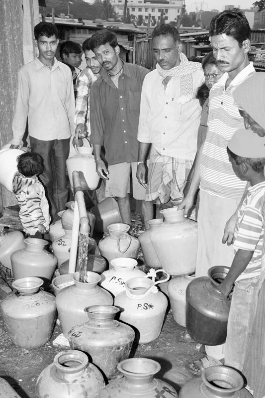 Men and Drinking Water Procurement - Queuing up for water at a community borewell in Bengaluru city, Karnataka